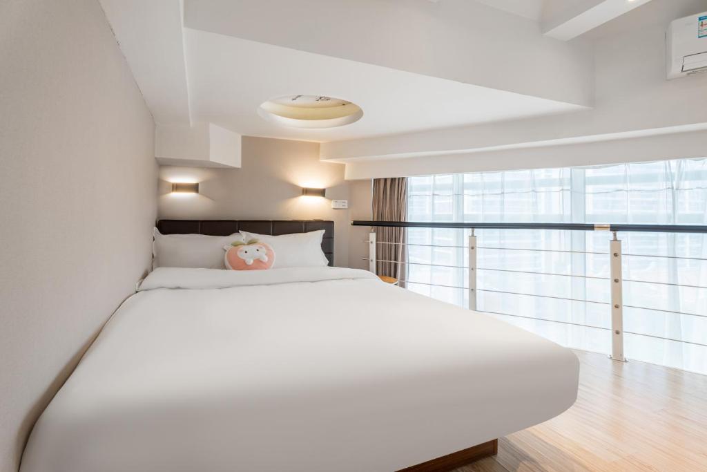 Postel nebo postele na pokoji v ubytování Shanghai Meego Qingwen Hotel