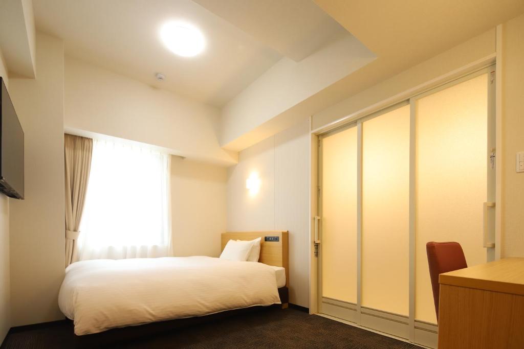 Ένα ή περισσότερα κρεβάτια σε δωμάτιο στο AB Hotel Anjo