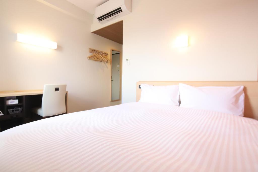 Postel nebo postele na pokoji v ubytování AB Hotel Igaueno