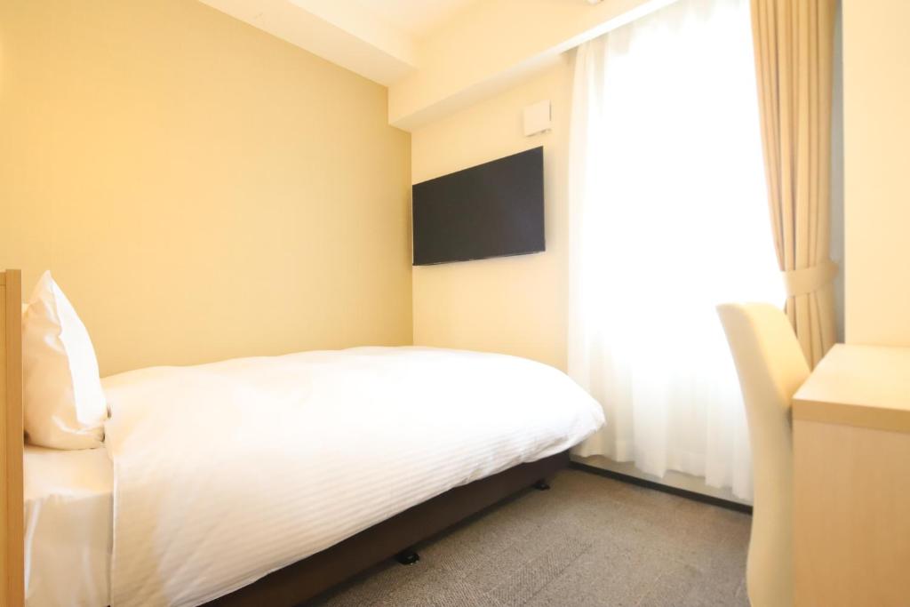 Postel nebo postele na pokoji v ubytování AB Hotel Igaueno