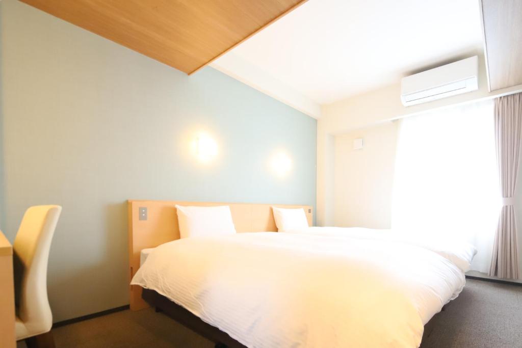 Postel nebo postele na pokoji v ubytování AB Hotel Igaueno