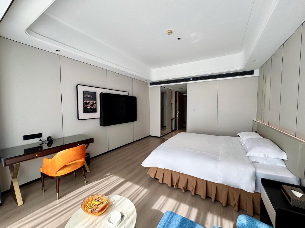 Postel nebo postele na pokoji v ubytování Dongguan Kai Benli International Hotel