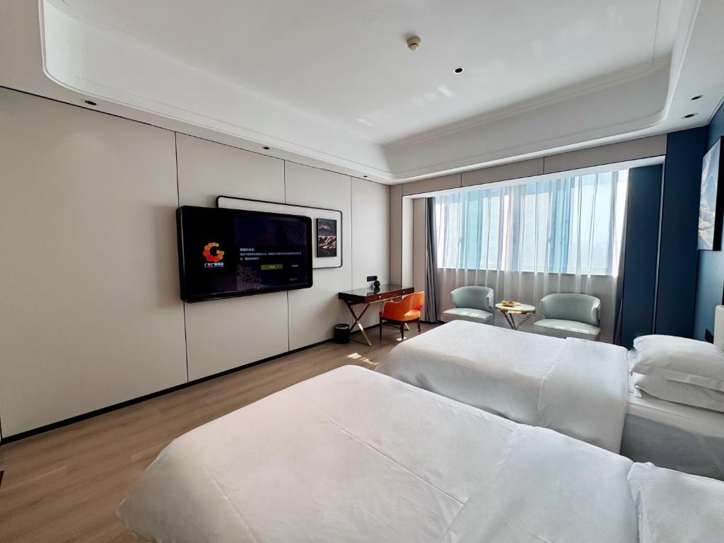 Postel nebo postele na pokoji v ubytování Dongguan Kai Benli International Hotel