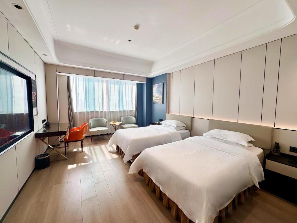 Postel nebo postele na pokoji v ubytování Dongguan Kai Benli International Hotel