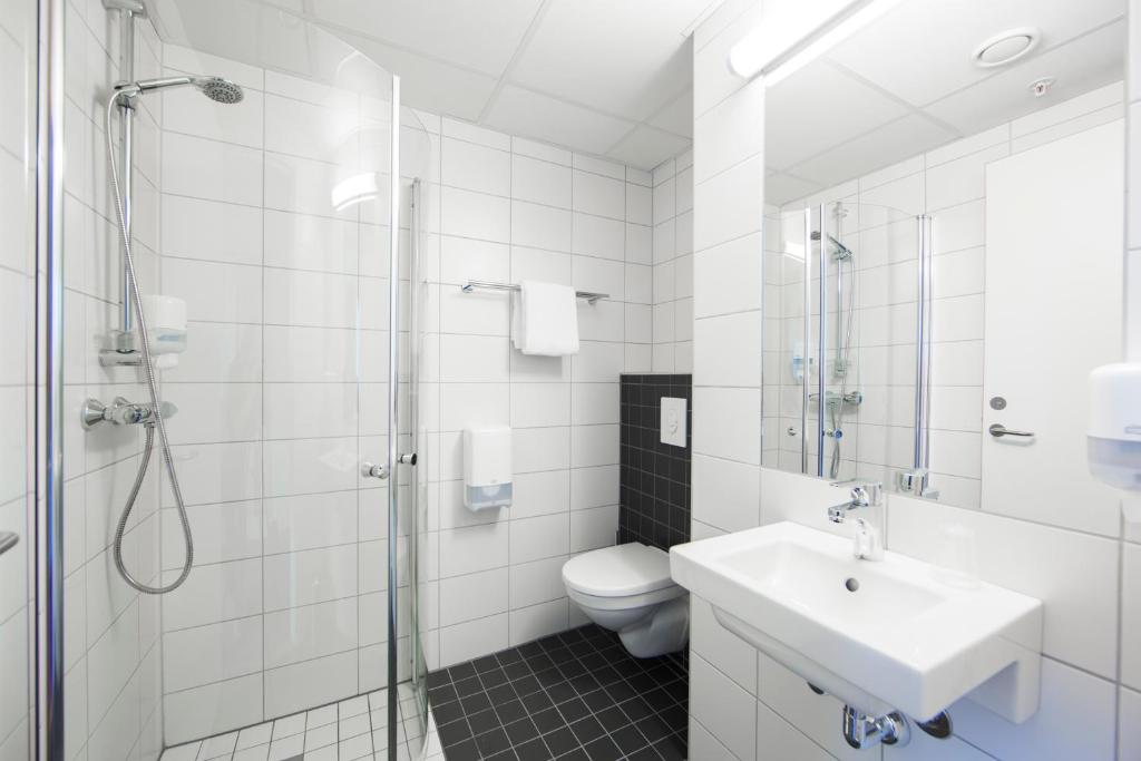 a bathroom with a toilet and a sink and a shower at Citybox Oslo in Oslo