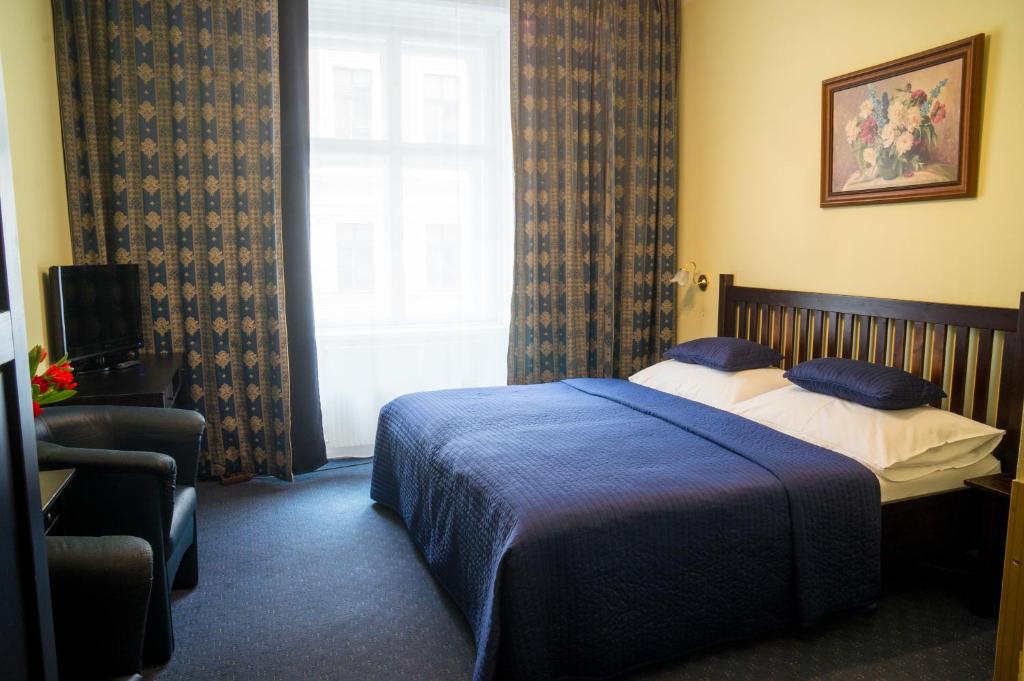 Postel nebo postele na pokoji v ubytování Hotel Bajazzo