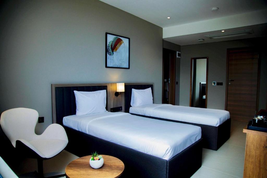 Postel nebo postele na pokoji v ubytování New Amaan Hotel
