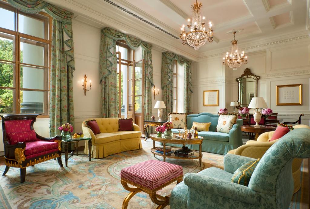 a living room filled with furniture and decor at Four Seasons Hotel Lion Palace St. Petersburg in Saint Petersburg