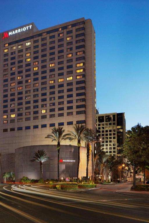 a large building with palm trees in front of it at Miami Marriott Dadeland in Miami