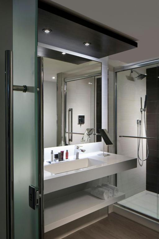 a bathroom with a sink and a large mirror at Miami Marriott Dadeland in Miami