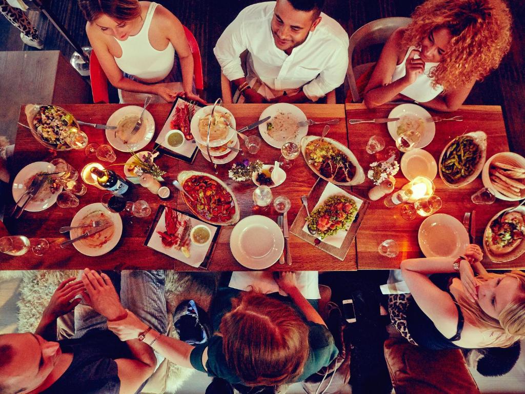 a group of people sitting around a table eating food at 25hours Hotel Bikini Berlin in Berlin