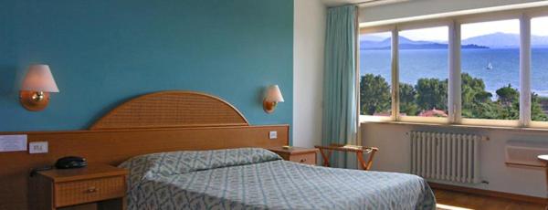 Postel nebo postele na pokoji v ubytování Hotel Cavalieri