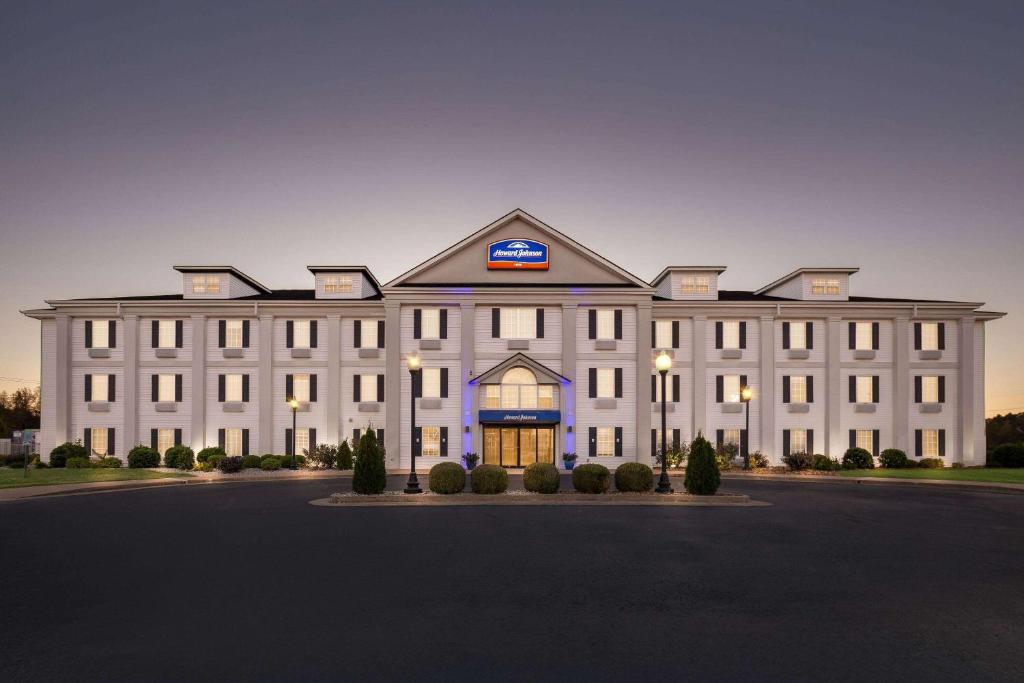 a large white building with a sign on it at Howard Johnson by Wyndham Jackson in Jackson
