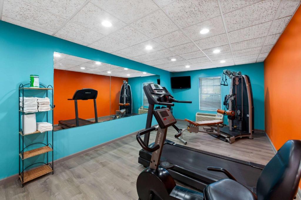 a gym with a treadmill and a mirror at Howard Johnson by Wyndham Jackson in Jackson