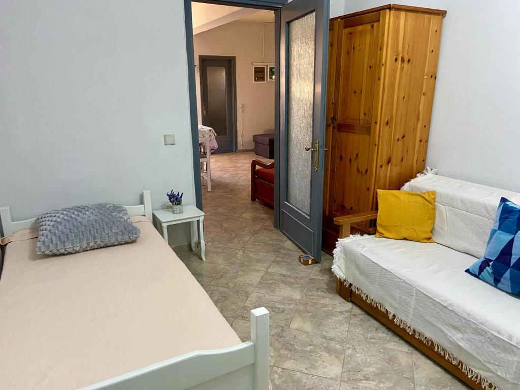 a bedroom with two beds and a door to a room at Farm Villa in Áyios Pávlos
