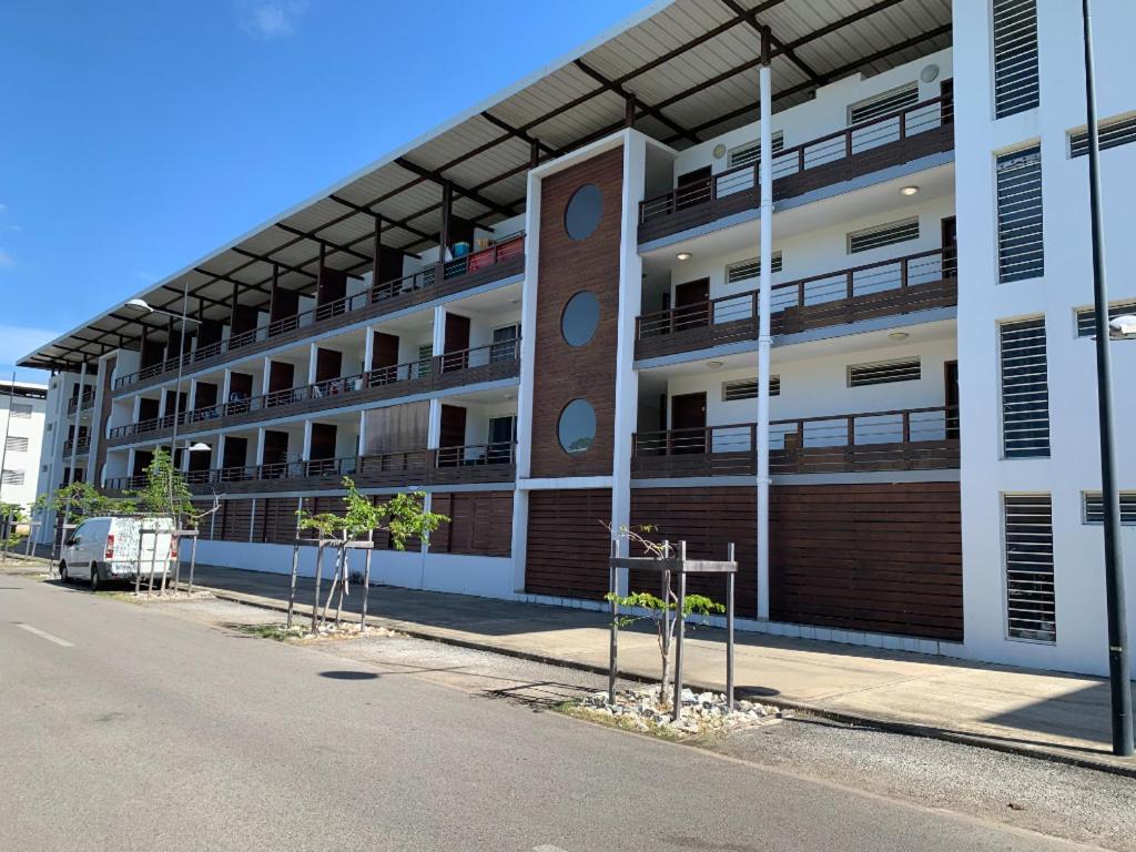 an apartment building with balconies on the side of a street at Design Appart in Cayenne