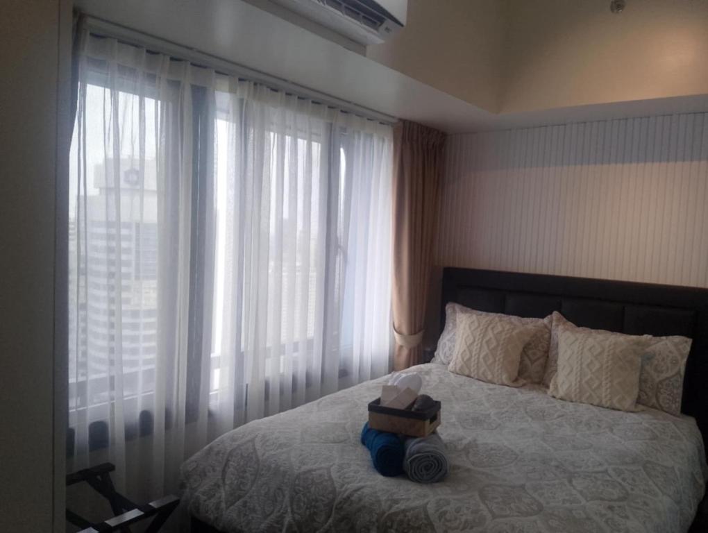 Voodi või voodid majutusasutuse E & T Homecations 2 Bedroom Apartment at SMDC Air Residences toas