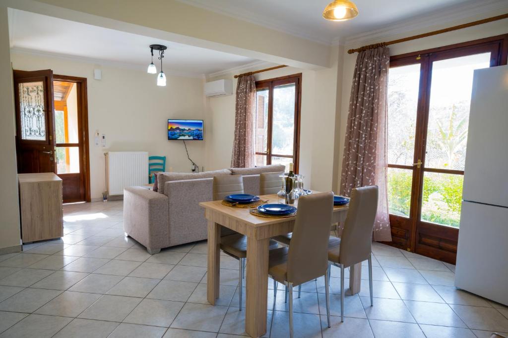 a kitchen and living room with a table and chairs at Almond's Room in Mirina