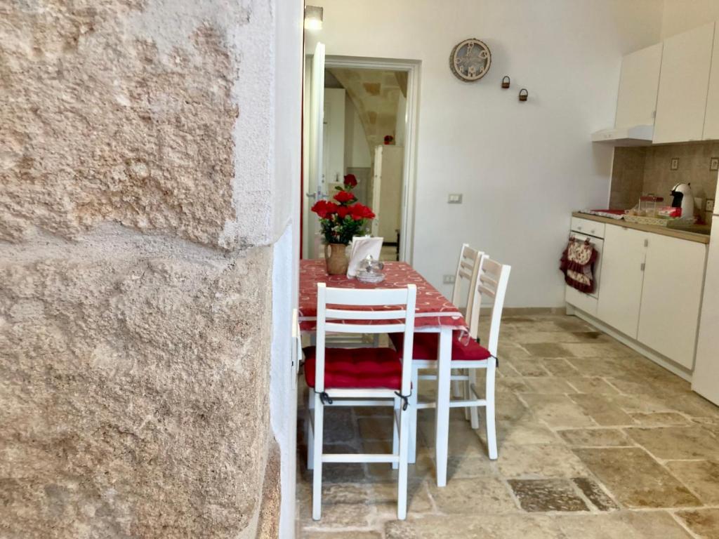 a kitchen and dining room with a table and chairs at Antica Pietra in Polignano a Mare