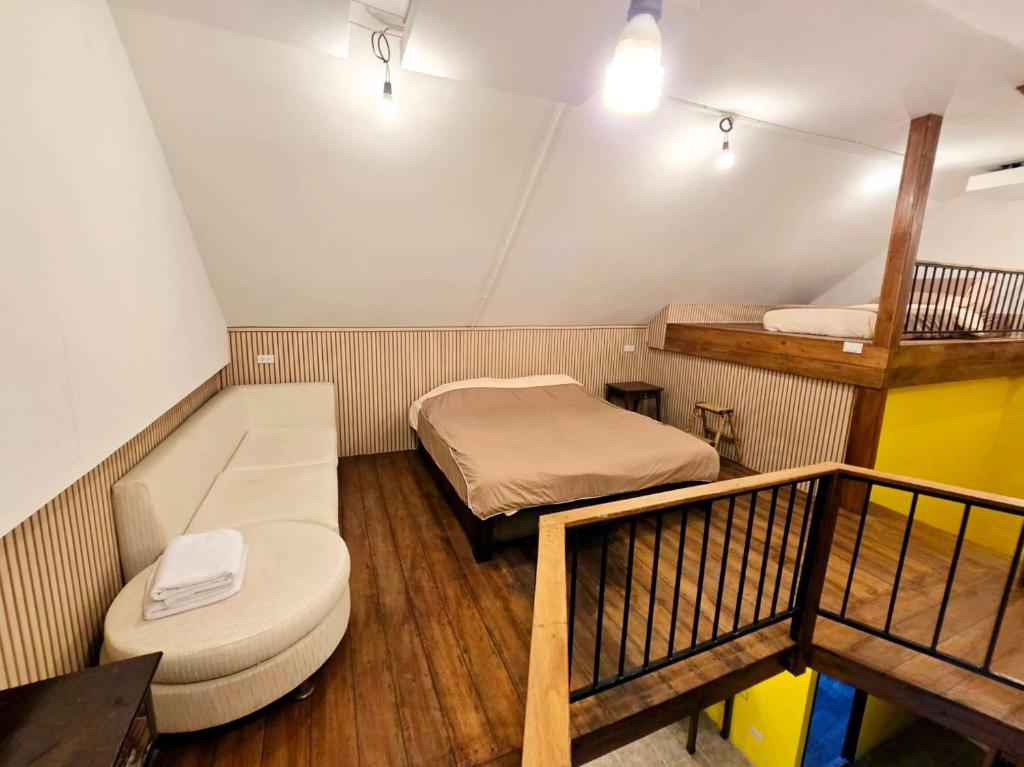 a small room with two beds and a balcony at Baibon3 Homestay Thalang Phuket in Ban Na Nai