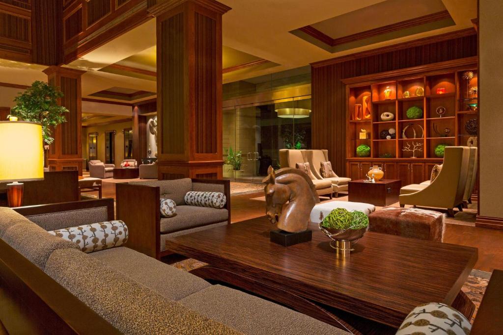 a living room with a couch and a table at The Westin Houston Downtown in Houston