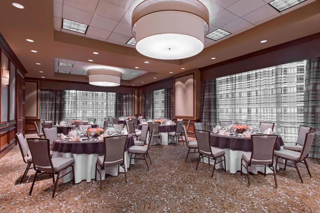 a banquet room with tables and chairs and windows at The Westin Houston Downtown in Houston