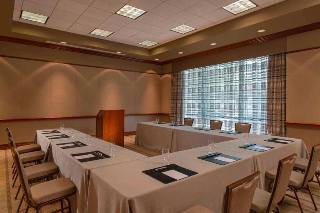 a conference room with tables and chairs and a large window at The Westin Houston Downtown in Houston