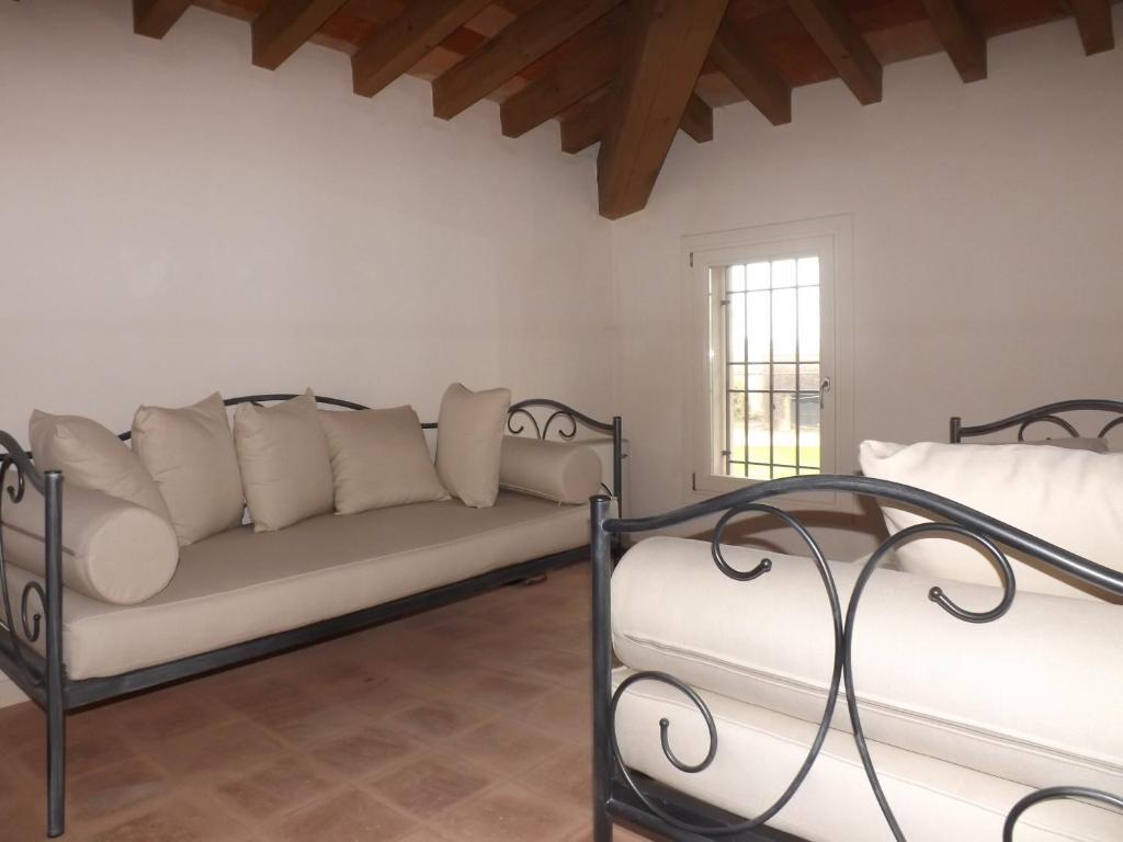 salon z kanapą i oknem w obiekcie Ostello Castello Mina Della Scala w mieście Casteldidone