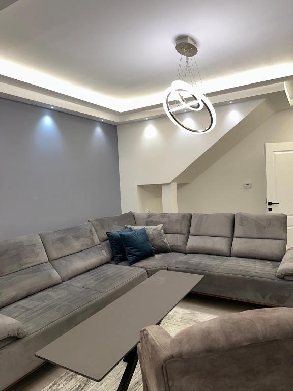a living room with a large couch and a table at Villa Luca Free Parking in Sarajevo