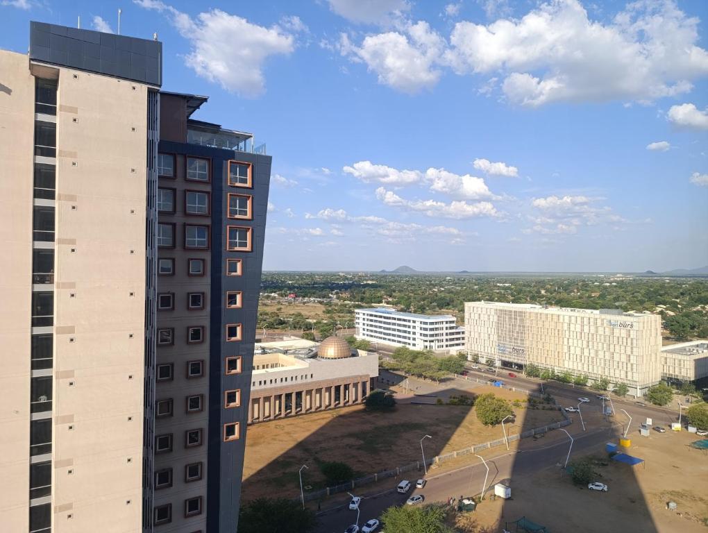 an aerial view of a city with a tall building at Golden Oasis at Itowers in Gaborone