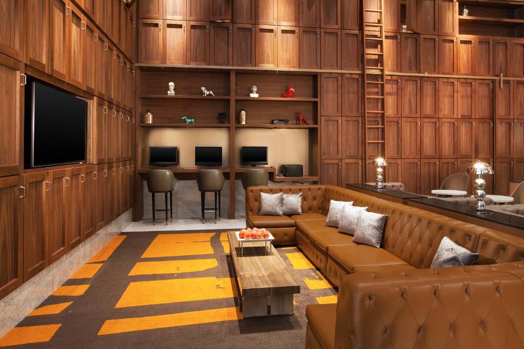 a living room with a couch and a bar at Sheraton Grand Los Angeles in Los Angeles