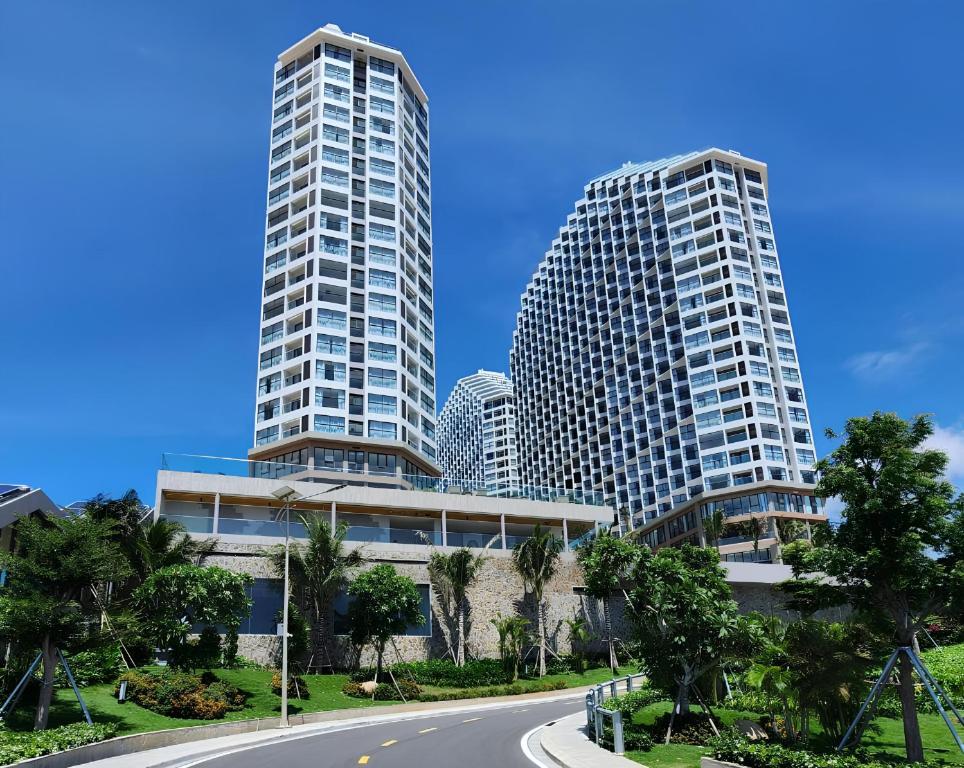 two tall buildings in a city with a road at Mandala Retreat Horizon Resort Mũi Né in Mui Ne