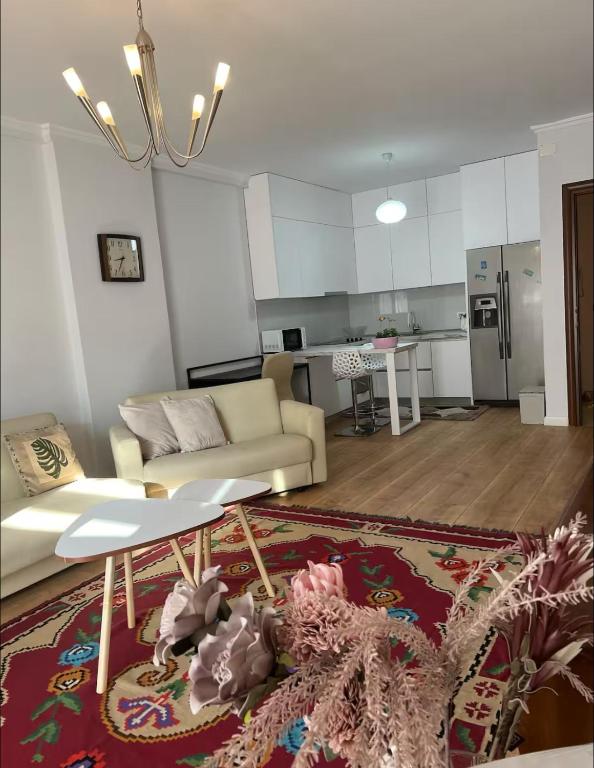a living room with a couch and a kitchen at Mbyllur in Tirana