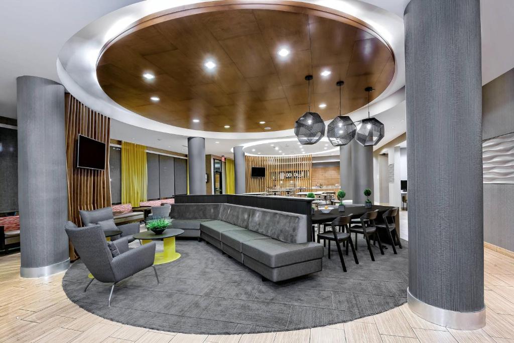 a living room with a couch and a dining room at SpringHill Suites by Marriott San Antonio SeaWorld®/Lackland in San Antonio