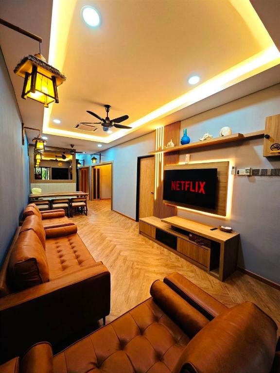 a living room with a couch and a television at Zen at Austin - Sleep 13 Pax-10 Min to Aeon Tebrau in Johor Bahru