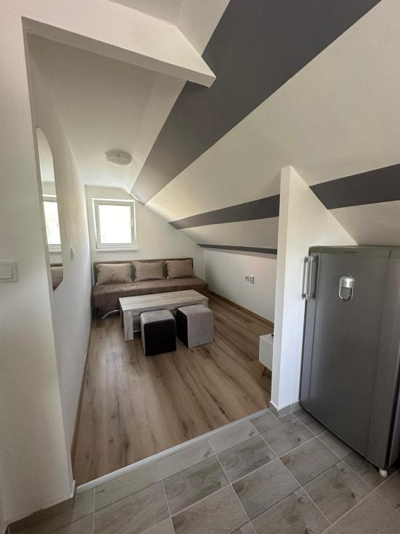a living room with a couch and a table at Apartman Rim 