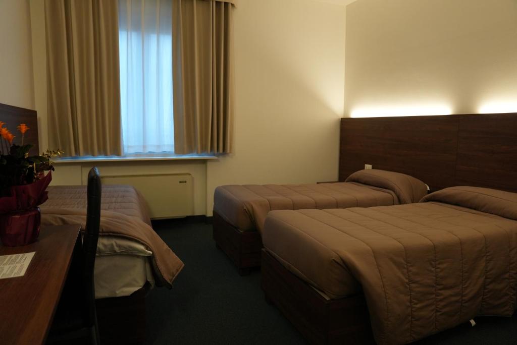 Postel nebo postele na pokoji v ubytování Hotel Albatros