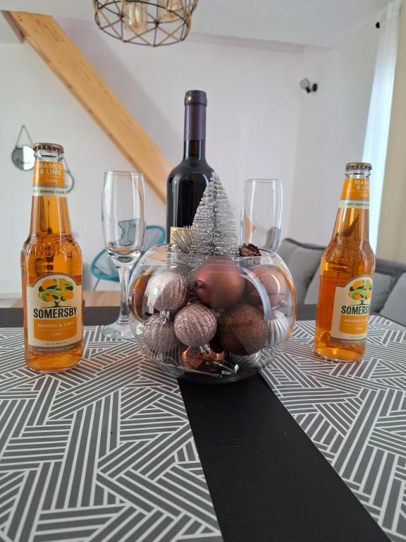 a table with bottles of wine and a bowl of nuts at UtopiaMS in Riječani