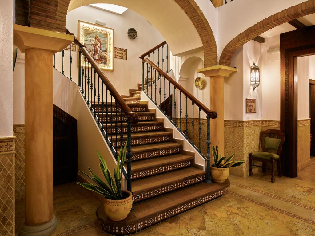a spiral staircase in a house with plants at Apartamentos Turísticos Casa de La Borrega in Estepona