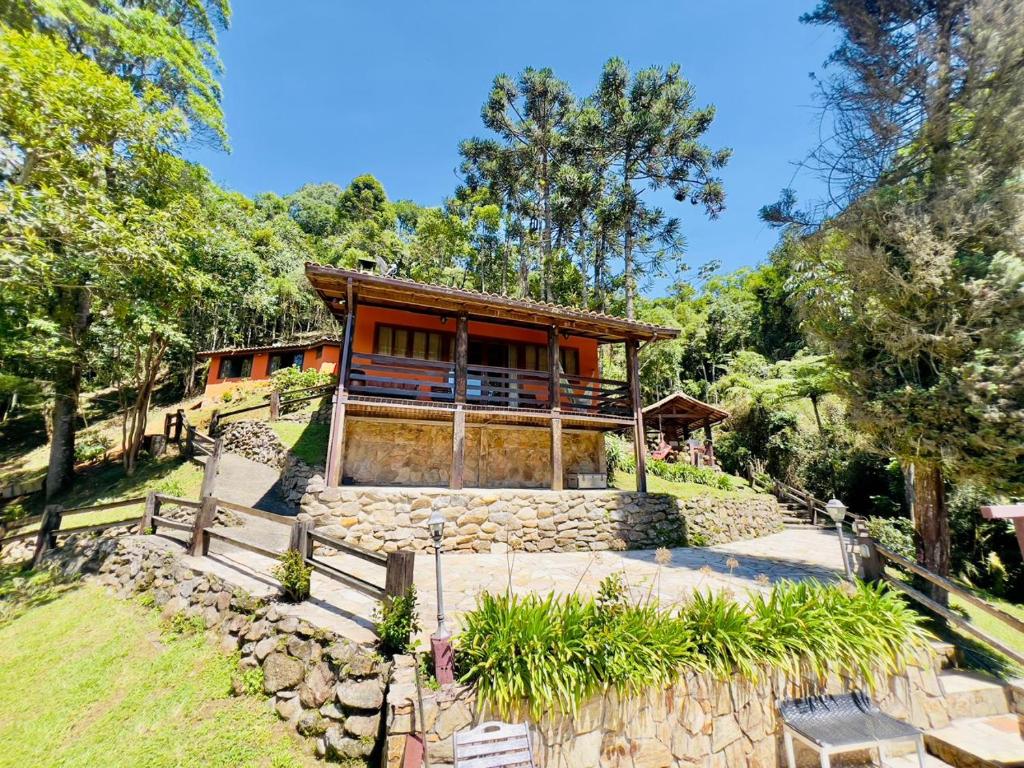 une maison au milieu d'un champ avec des arbres dans l'établissement Casa da Mel, à Itatiaia