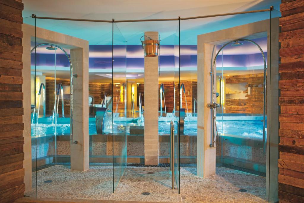 a glass door leading into a room with a bedroom at Secrets Vallarta Bay Resort & SPA - Adults Only in Puerto Vallarta