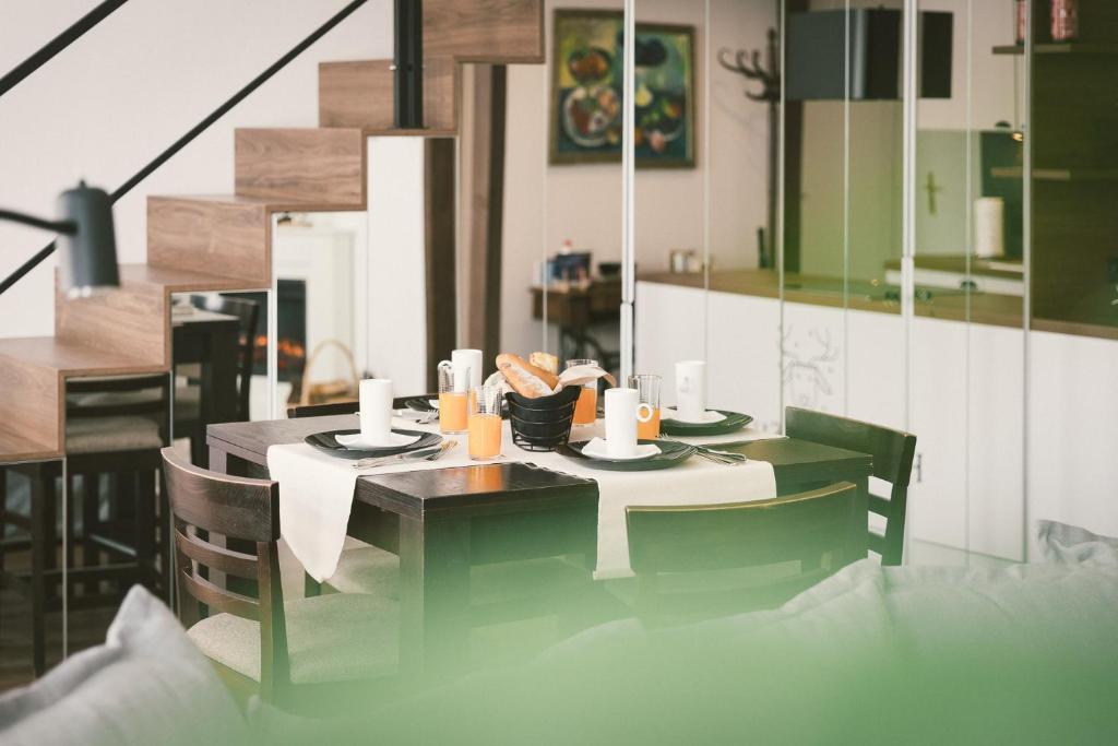 a dining room with a table with food on it at "Hunter's Suite"- at the heart of Hartberg I Parking in Hartberg