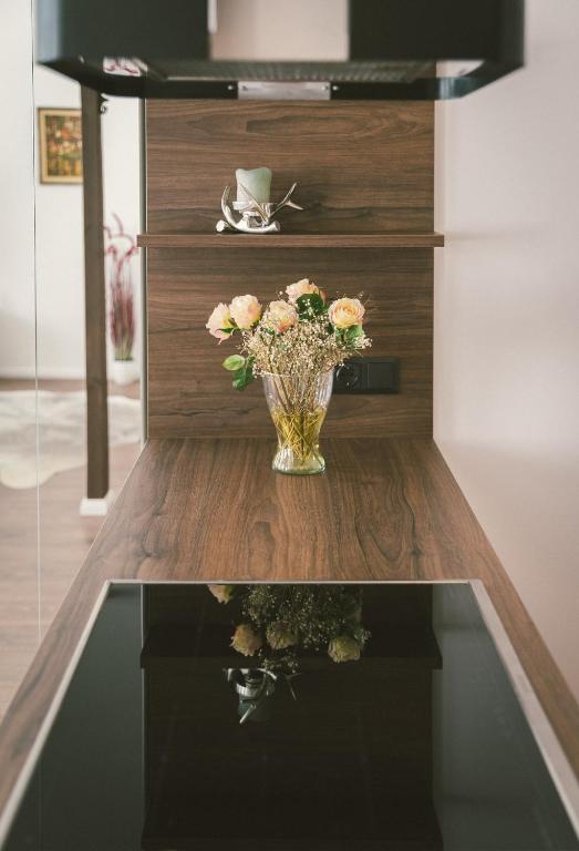 a vase of flowers sitting on a table at "Hunter's Suite"- at the heart of Hartberg I Parking in Hartberg