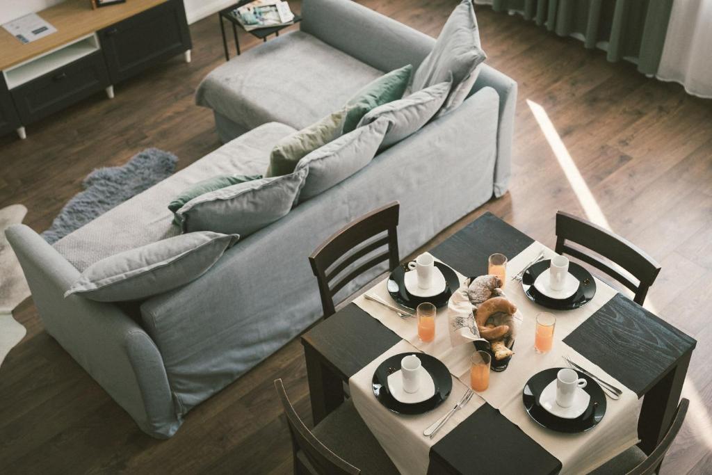 a living room with a couch and a table at "Hunter's Suite"- at the heart of Hartberg I Parking in Hartberg