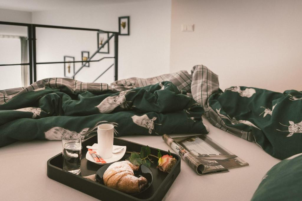 a tray of food on a table next to a bed at "Hunter's Suite"- at the heart of Hartberg I Parking in Hartberg
