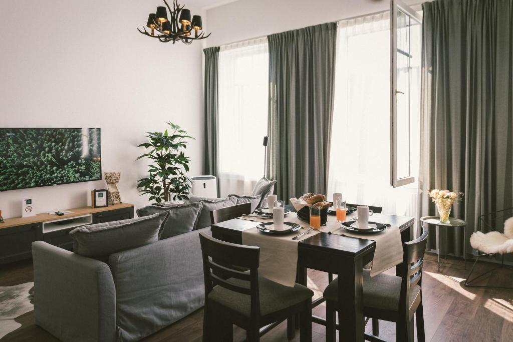 a living room with a table and a couch at "Hunter's Suite"- at the heart of Hartberg I Parking in Hartberg