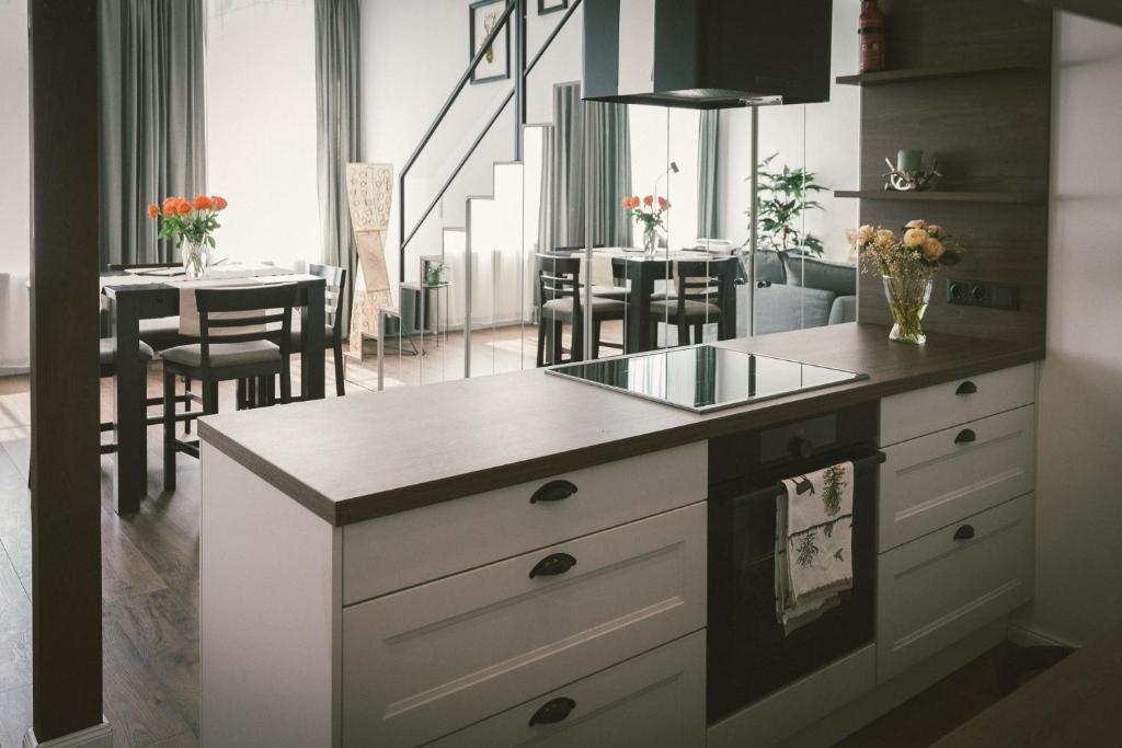 a kitchen with a counter and a dining room at "Hunter's Suite"- at the heart of Hartberg I Parking in Hartberg