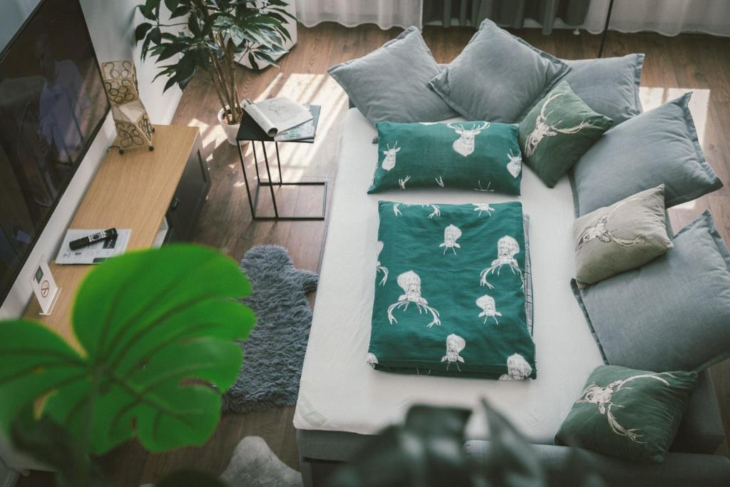 a couch with pillows on it in a living room at "Hunter's Suite"- at the heart of Hartberg I Parking in Hartberg