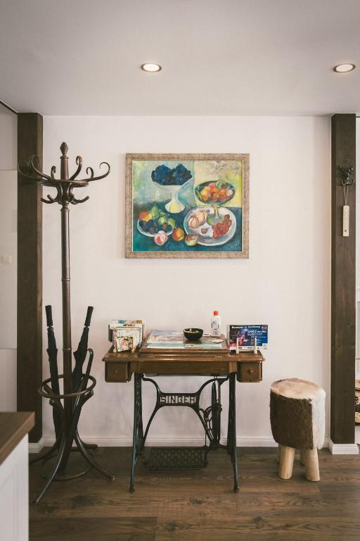a table in a room with a painting on the wall at "Hunter's Suite"- at the heart of Hartberg I Parking in Hartberg