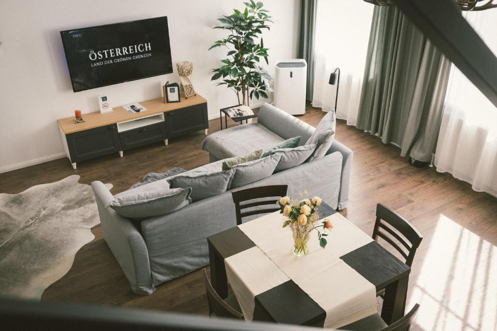 a living room with a couch and a table at "Hunter's Suite"- at the heart of Hartberg I Parking in Hartberg